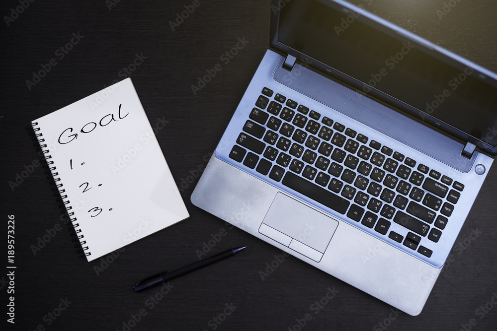 Notebook and computer on wood background. Notebook and computer on wood background.
