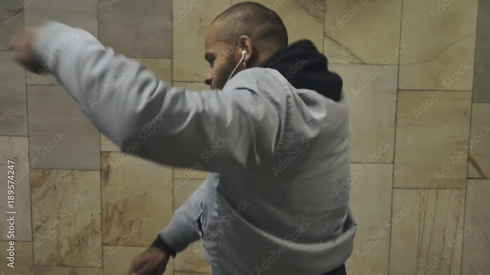 Black man dancing hip-hop in an underground crossing Black man dancing hip-hop in an underground crossing