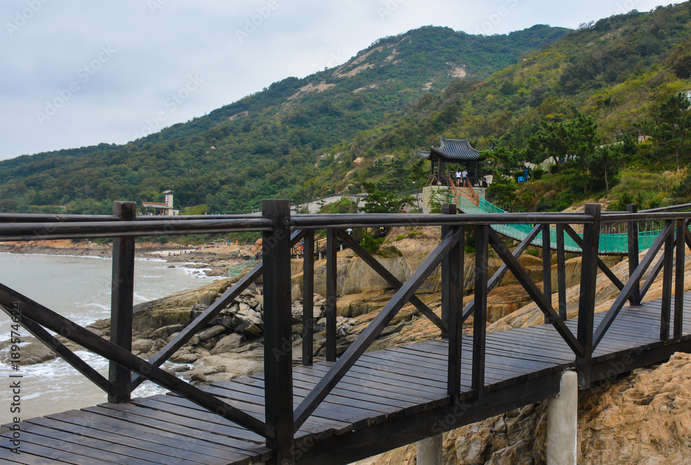 Wooden suspension bridge between mountains and sea in China Wooden suspension bridge between mountains and sea in China