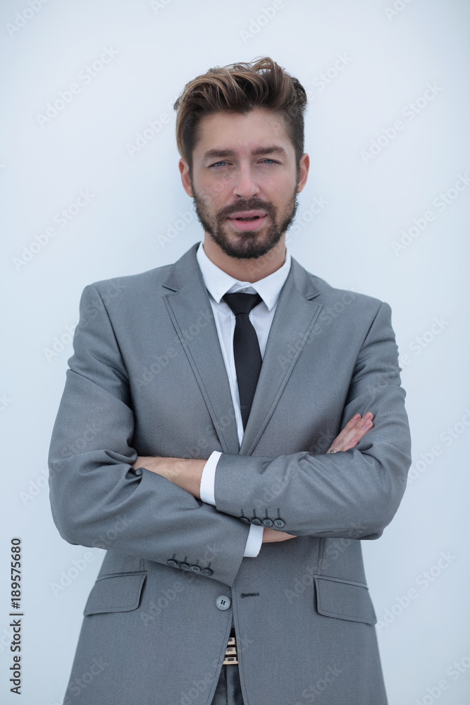 Confident bearded businessman standing with arms crossed Confident bearded businessman standing with arms crossed