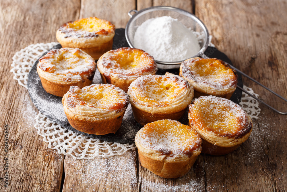 Fototapeta premium Homemade puff pastry with custard and powdered sugar close-up on the table. horizontal