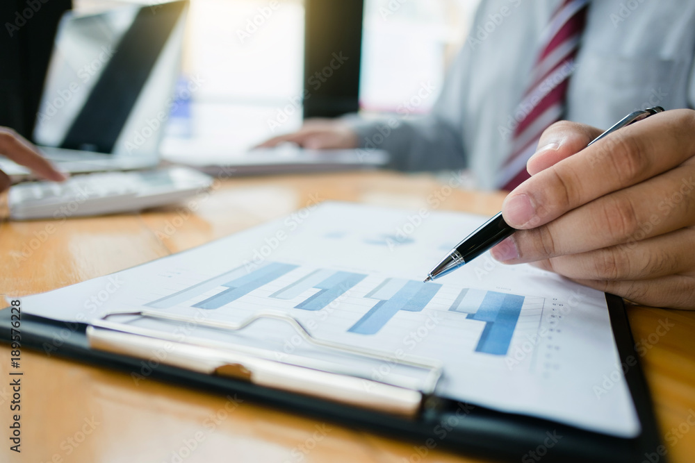financial inspecter analyzing investment charts with laptop and calculator, selective focus financial inspecter analyzing investment charts with laptop and calculator, selective focus