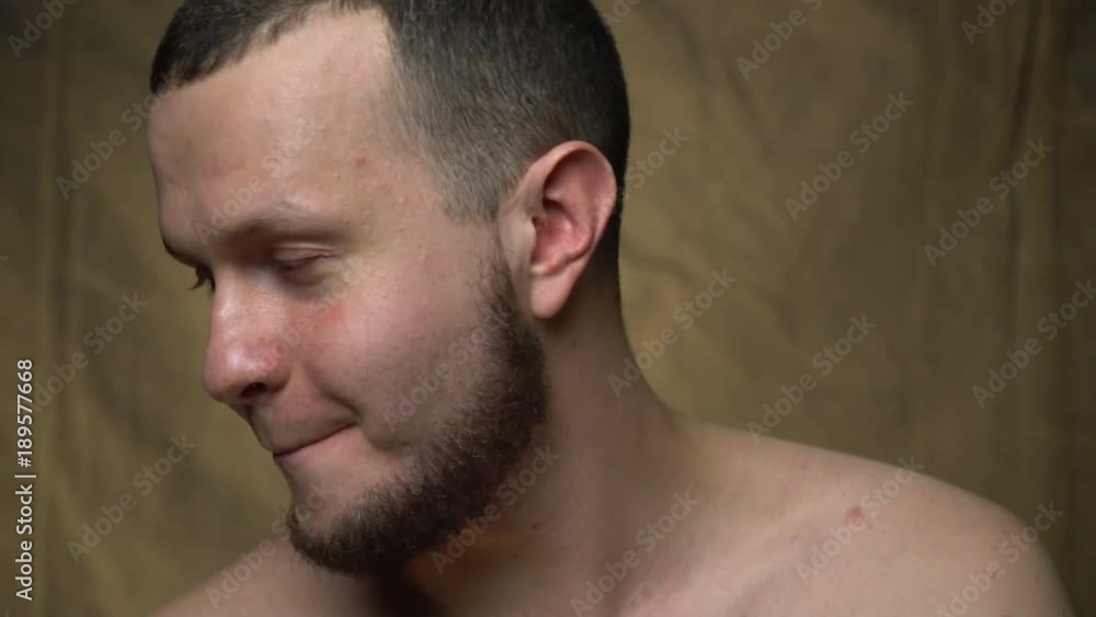 The man is topless and embarrassed The man is topless and embarrassed