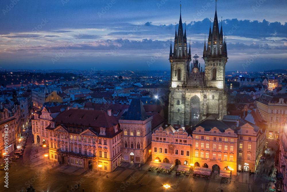 View from Town Hall Clock Tower to Church of Our Lady before Tyn on Old Town Square and Traditional old buildings at night after sunset in Prague, Czech Republic
