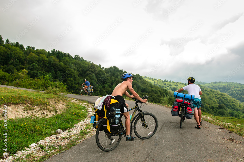 Obraz premium Bicyclists on the asphalt road in Abkhazia