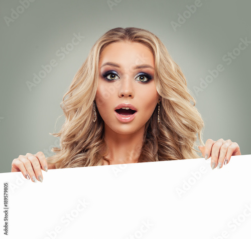 Happy Blonde Woman Fashion Model with White Blank Board Paper Banner Background