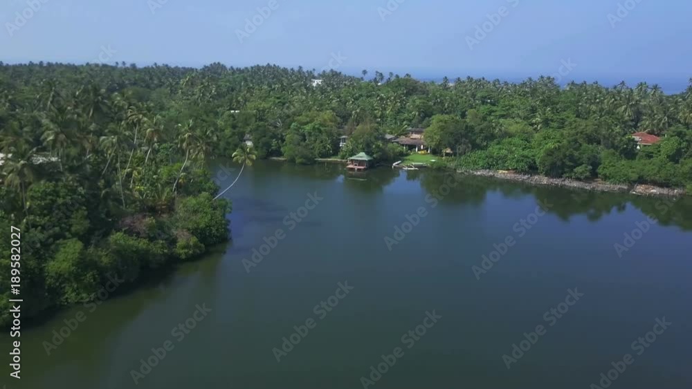 View of house on riverbank at sunrise drone footage View of house on riverbank at sunrise drone footage