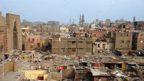 The view from the Bab Zuwayla gate on the slums of Islamic Cairo, Al Muizz street of Khan El Khalili bazaar and facade of Sultan al-Mu'ayyad mosque, Egypt. photo