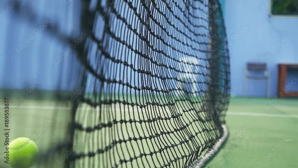Slow motion of tennis ball hits the grid falling on a tennis court in sunny day. 1920x1080 Slow motion of tennis ball hits the grid falling on a tennis court in sunny day. 1920x1080
