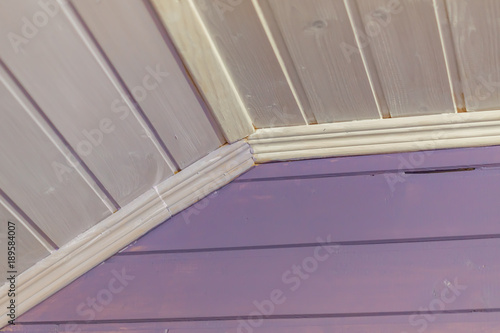 wooden wall and ceiling painted in purple. interior of country house