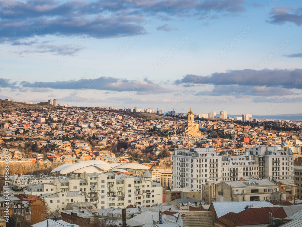 Fototapeta premium aerial view of city in Georgia and sky at sunset