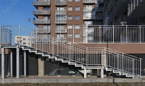 A silver  metal ramp and stairs for wheelchairs in a  mass production city house