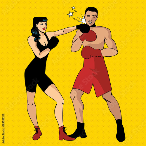 The war of the sexes. Beautiful girl boxer hitting her handsome opponent with a left hook