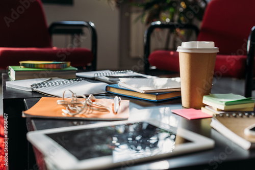 Wallpaper Mural tablet with disposable coffee cup and notebooks on table Torontodigital.ca