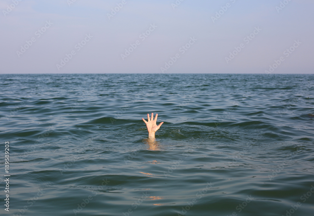 hand of the person who is about to drown in the ocean hand of the person who is about to drown in the ocean