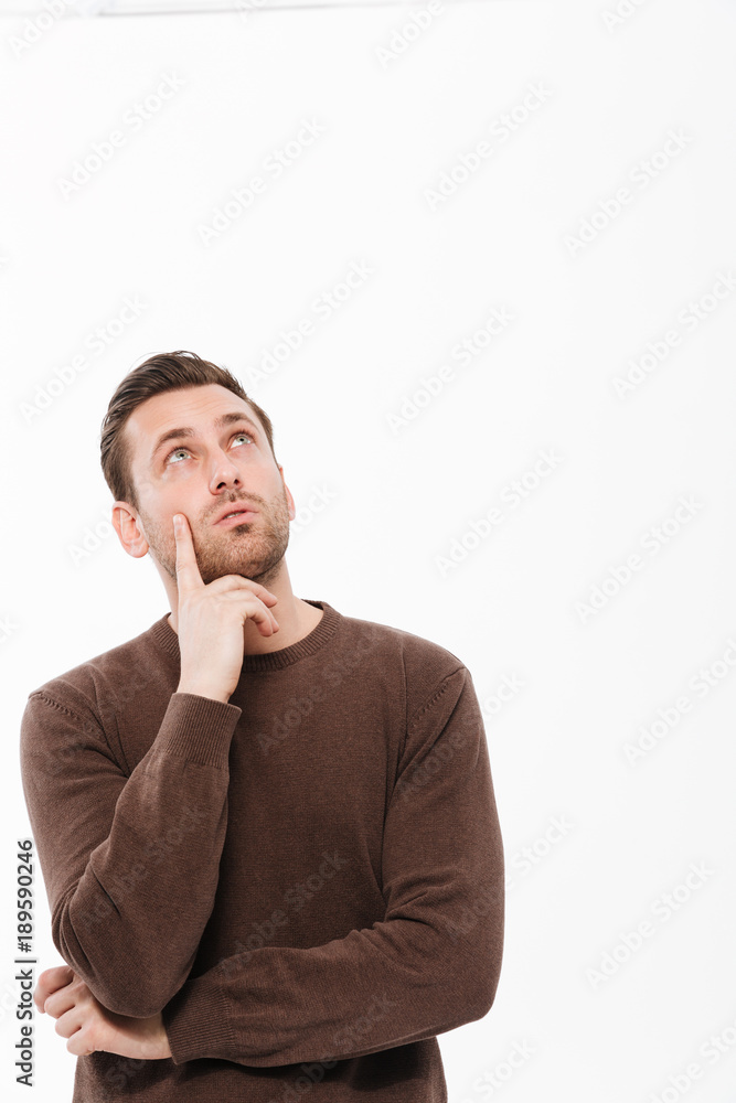 Thinking young man standing isolated Thinking young man standing isolated