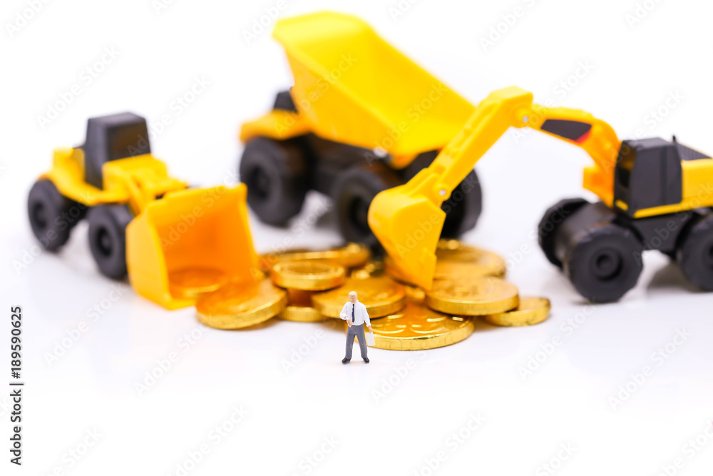 Miniature people : engineer or technician of construction workers with gold coins,engineer and business concept. Miniature people : engineer or technician of construction workers with gold coins,engineer and business concept.