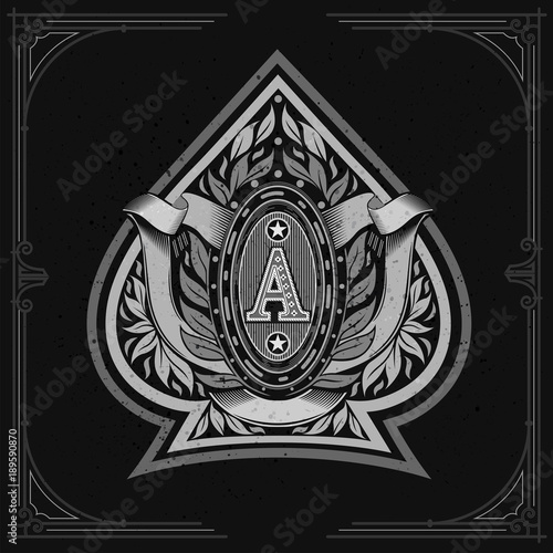 Ace of spades form with oval frame between laurel wreth and ribbon inside. Design playing card element white on black