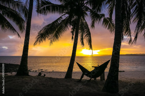 Man Relaxing in Hammock on Sunset Paradise Beach - Siargao Island, Philippines