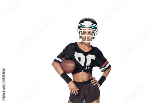 stylish female american football player with ball looking at camera isolated on white