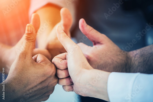 group of business teamwork hand togetrher with thumbs up for successful deal and concept photo