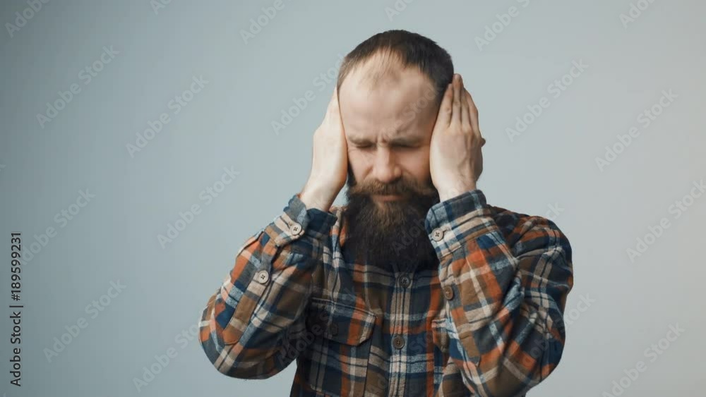 Bearded hipster man suffering from headache emotional stress Bearded hipster man suffering from headache emotional stress