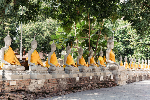 Row of Buddha's statues in front of a temple