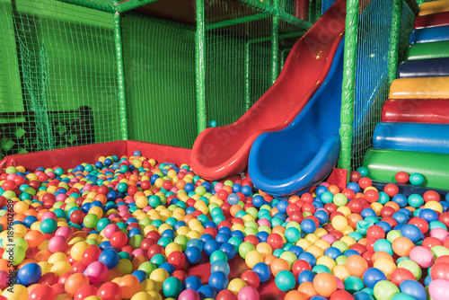 slides and pool with colorful balls in entertainment center