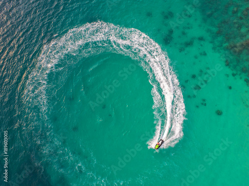 People are playing a jet ski in the sea.Aerial view. Top view.amazing nature background.The color of the water and beautifully bright. Fresh freedom. Adventure day.clear turquoise at tropical beach.