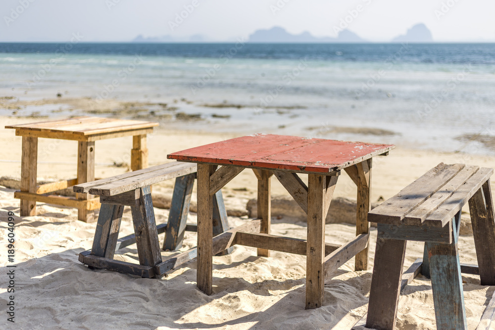 Wooden table on the beach in morning light, retro style