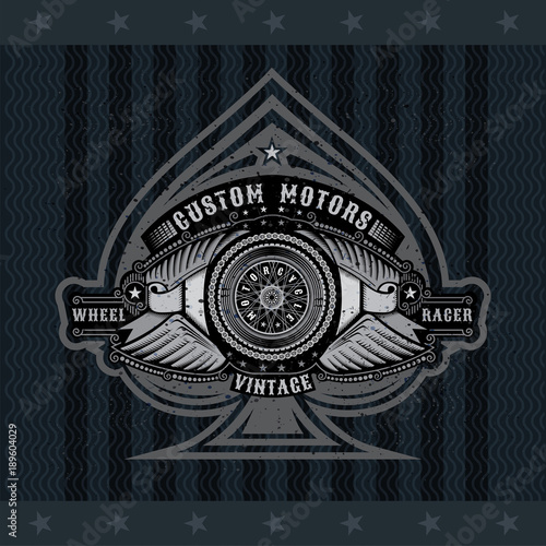 Ace of spades with motorbike wheel in center of chain between two pair of wings and ribbons. Motorcycle design for print or card on blackboard