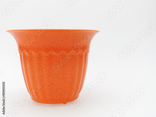 Empty plastic brown and orange plant pot with dotted and stripped isolated on white background