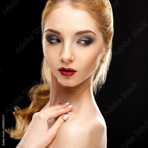 Close-up beauty portrait of perfect young woman with golden hair and evening makeup