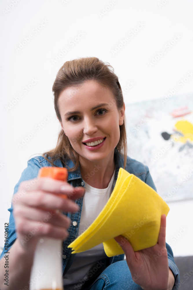 portrait of attractive woman with rag and disinfect spray cleaning home portrait of attractive woman with rag and disinfect spray cleaning home