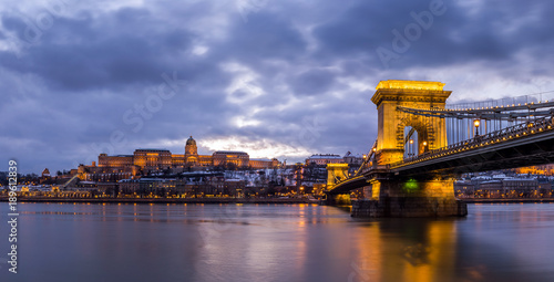 Budapest, Hungary - Beautiful illuminated Szechenyi Chain Bridge over River Danube with Buda Castle Royal Palace at blue hour