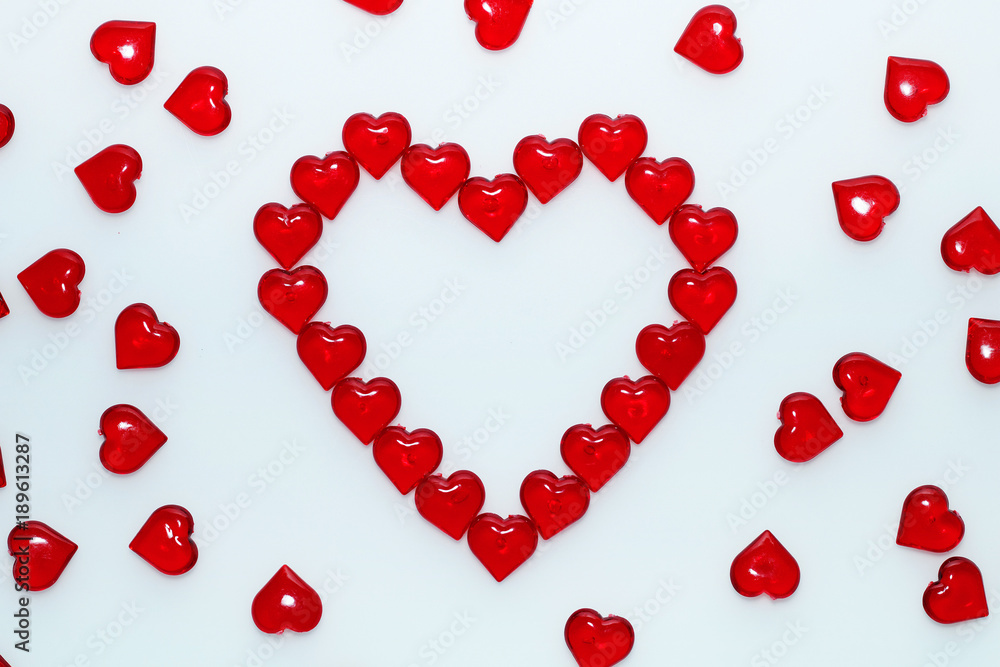 Background for St. Valentine's Day.
Decorative red hearts on a white background