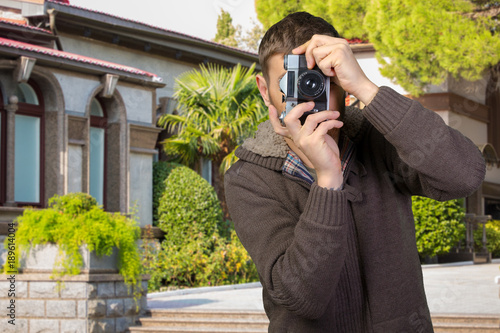 Young man with camera photo