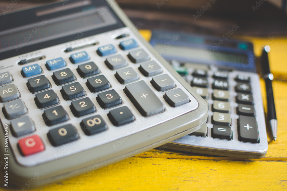 Calculator close-up shot focus On the yellow wood desk Calculator close-up shot focus On the yellow wood desk