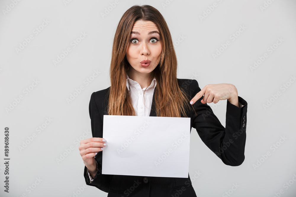 Funny lady grimacing and pointing at white sheet isolated Funny lady grimacing and pointing at white sheet isolated