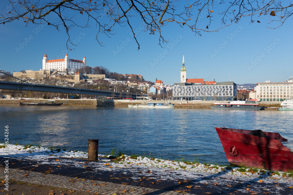 Bratislava - The riverside in winter with the castle and cathedral in the background.