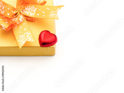 a red heart-shaped chocolate candy and a present box