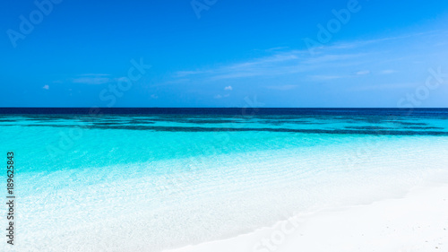 Fototapeta Naklejka Na Ścianę i Meble -  Turquoise lagoon of a tropical island. Turquoise lagoon of a tropical island in the ocean. White sand on the beach. Summer paradise for relaxation.