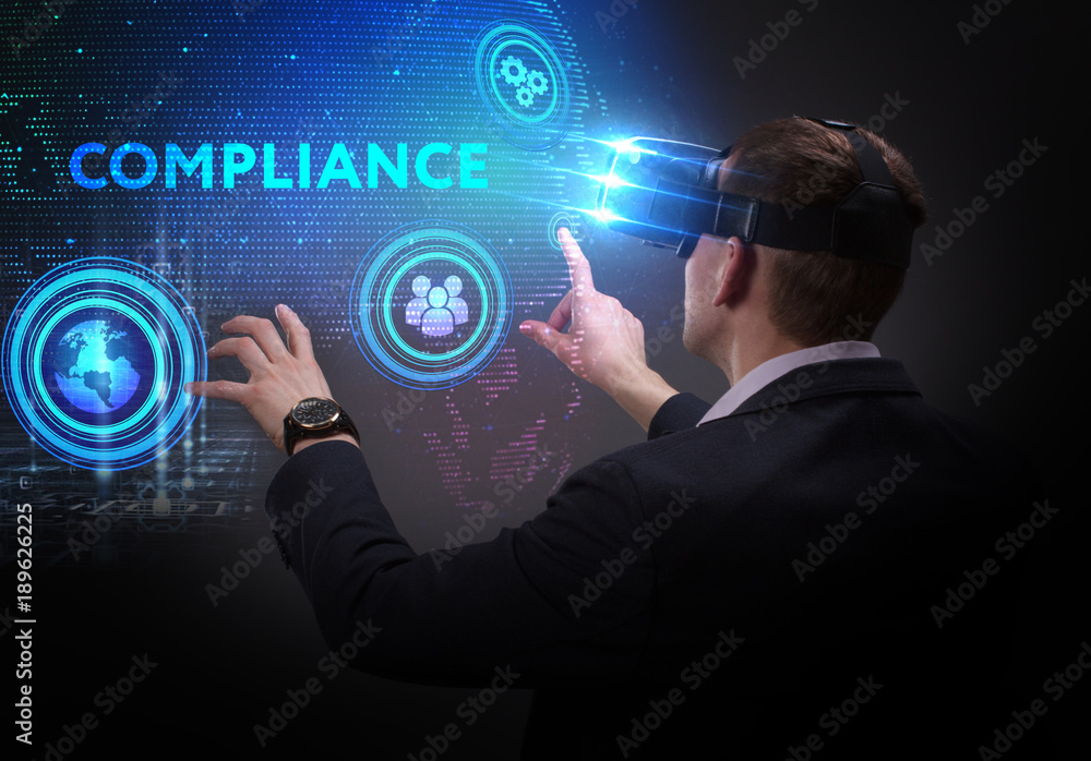 Business, Technology, Internet and network concept. Young businessman working on a virtual screen of the future and sees the inscription: Compliance Business, Technology, Internet and network concept. Young businessman working on a virtual screen of the future and sees the inscription: Compliance
