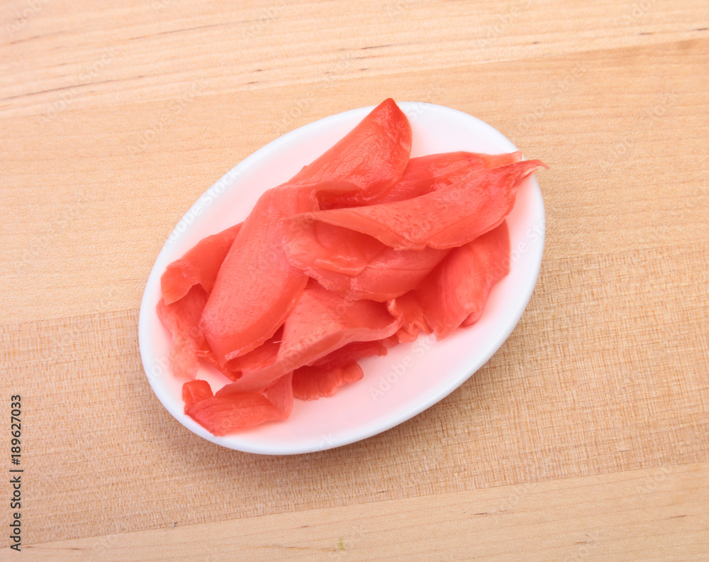 plate with Japanese pickled ginge on wood background. plate with Japanese pickled ginge on wood background.