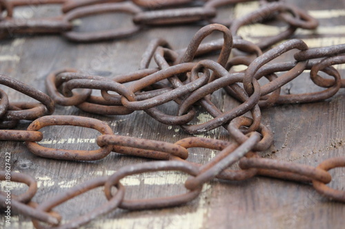 Old rusted chain on weathered wood.