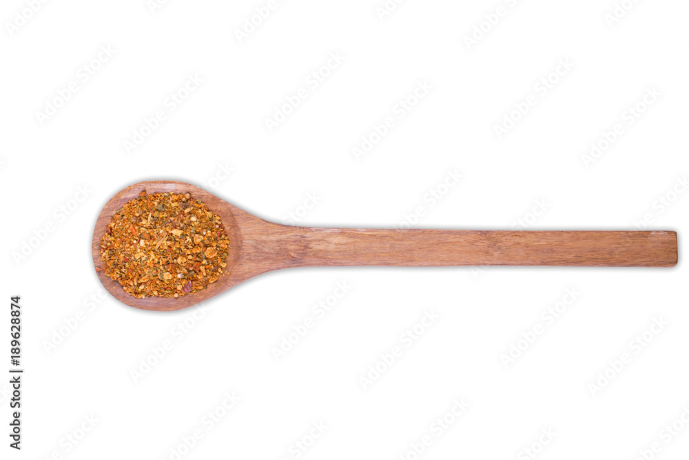 A pile of a yellow spice mix for on wooden spoon isolated on white background. Spices consist paprika onion garlic coriander turmeric black pepper basil dill A pile of a yellow spice mix for on wooden spoon isolated on white background. Spices consist paprika onion garlic coriander turmeric black pepper basil dill