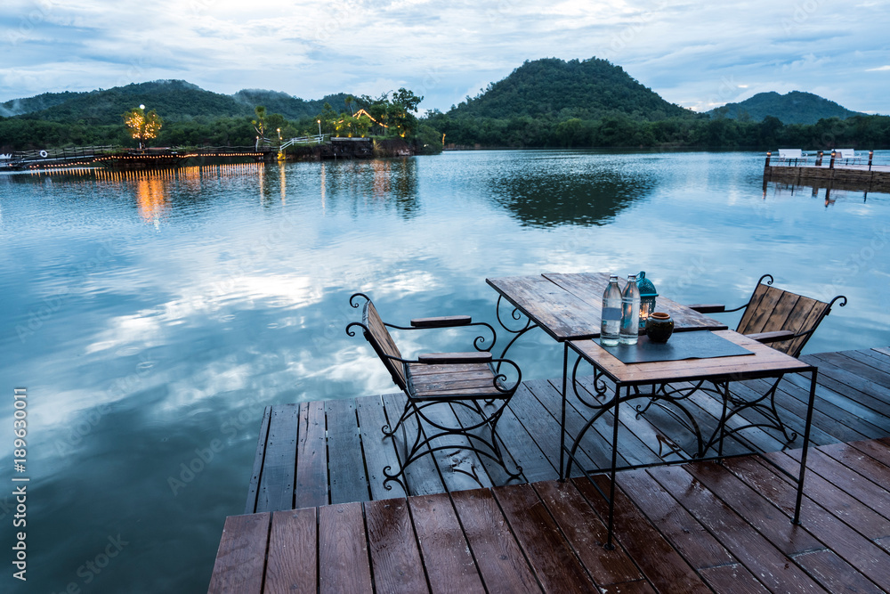 Outdoor restaurant with beautiful mountain view on the lake in the evening Outdoor restaurant with beautiful mountain view on the lake in the evening