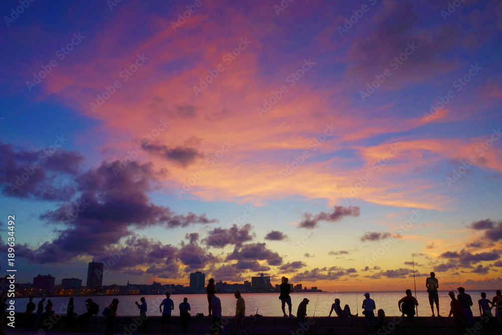 Sunset at Malecon, the famous Havana promenades where Habaneros, lovers and most of all individual fishermen meet, Havana, Cuba Sunset at Malecon, the famous Havana promenades where Habaneros, lovers and most of all individual fishermen meet, Havana, Cuba