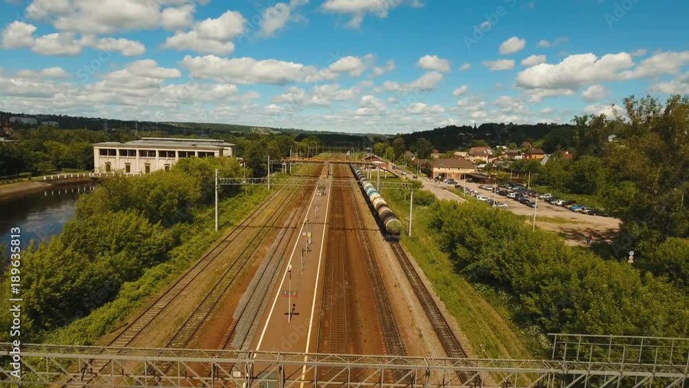 Aerial view railway station view from above. Freight train with cisterns and containers on the railway, aerial footage, 4k. Aerial view railway station view from above. Freight train with cisterns and containers on the railway, aerial footage, 4k.