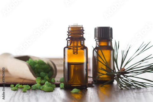 Fototapeta Naklejka Na Ścianę i Meble -  Pine essential oil, sea salt with pine oil and pine twigs